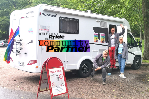 Hivpoint´s mobile unit where you can get tested for HIV during Helsinki Pride Week. Three Hibpoint´s workers in front of the camper van.