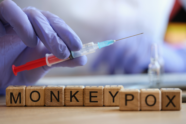 Vaccination needle and the text monkeypox.
