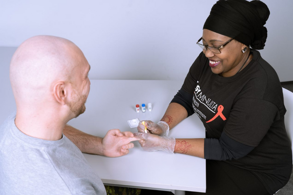 A person is doing an hiv test to another person