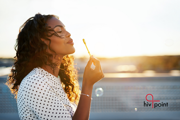 A woman blowing soap bubbles.