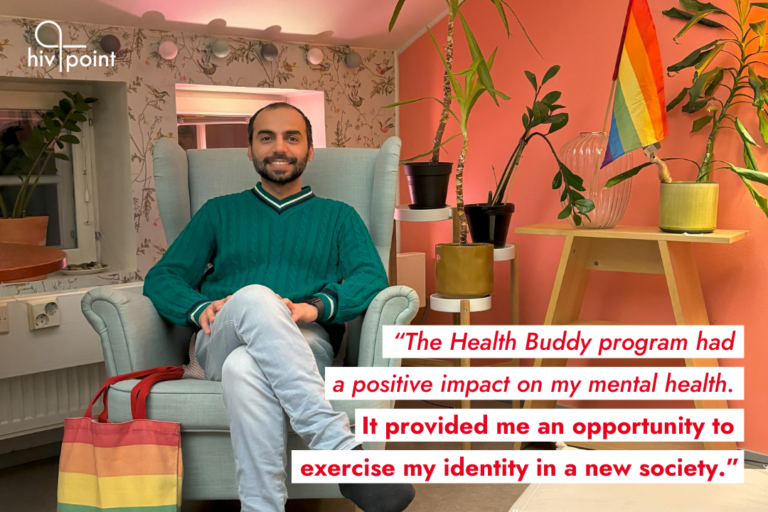 Hivpoint's Health Buddy Ali is smiling and sitting in an arm chair in a cozy, colorful room. The room is decorated with house plants and a Pride flag. On top of the photo, there's a quote: "The Health Buddy Program had a positive impact on my mental health. It provided me an opportunity to exercise my identity in a new society."