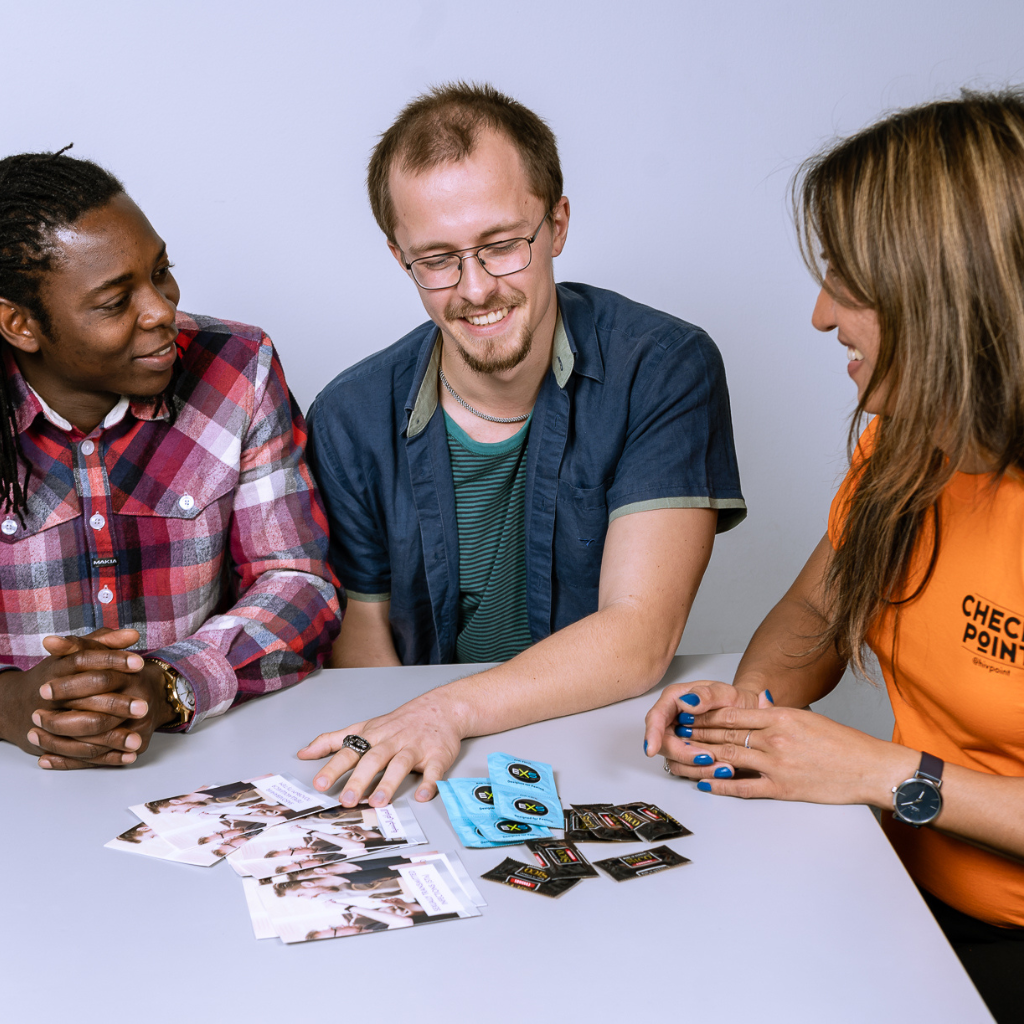 Three people discussing health issues using brochures on the table.